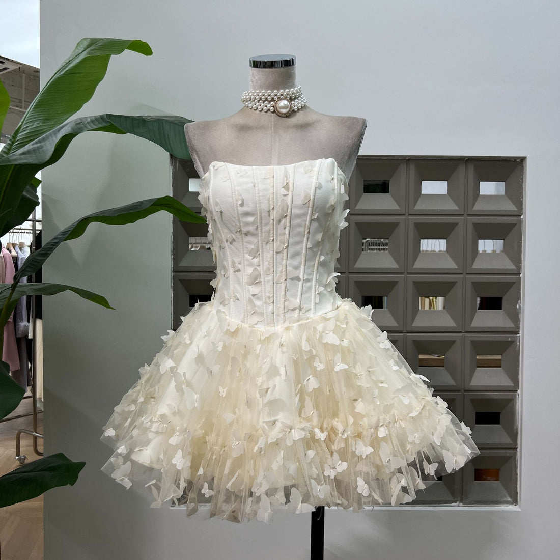 White lace dress with a matching headband on a light gray background