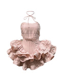 Pink dress with ruffled skirt on a white background