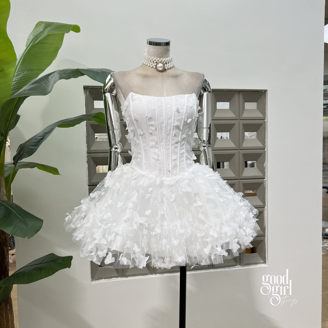 White lace dress with a belt on a light gray background