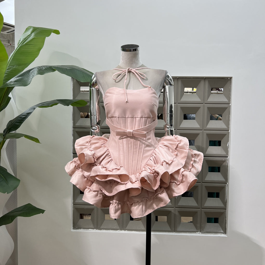 Pink dress with ruffled skirt on a white background